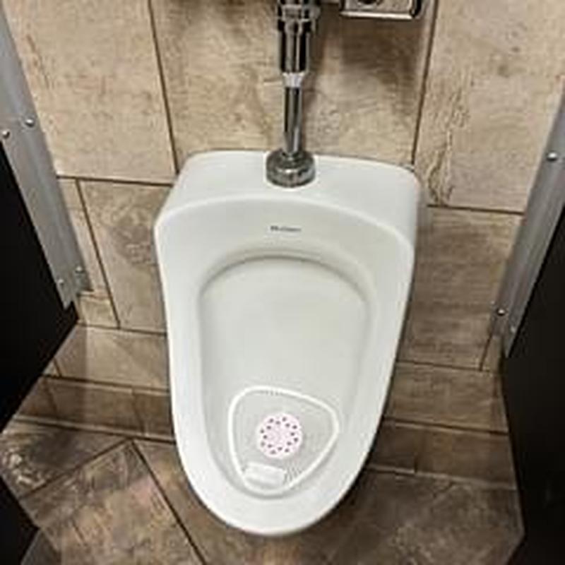 Urinal cleaning and descaling in commercial restroom Urinal cleaning and descaling in commercial restroom