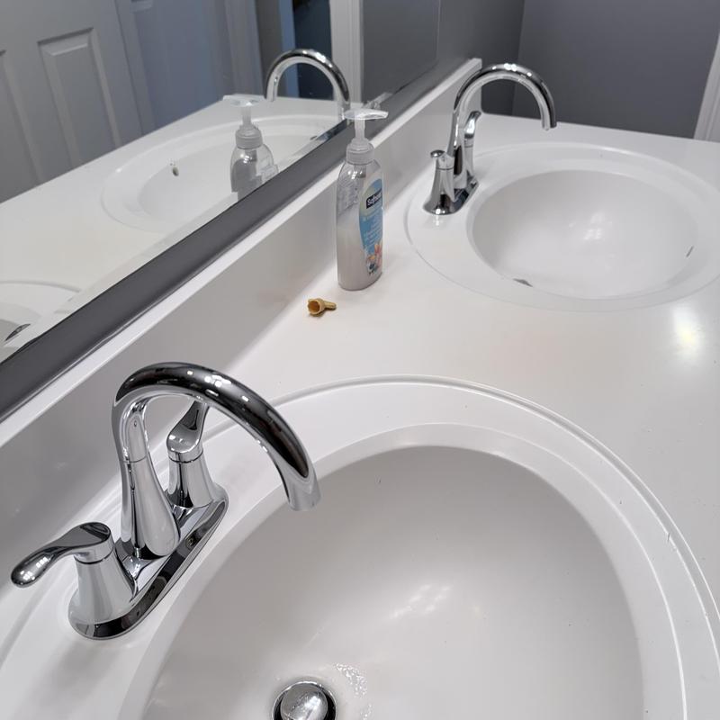 Double vanity faucets with soap dispenser and mirror reflection Double vanity faucets with soap dispenser and mirror reflection