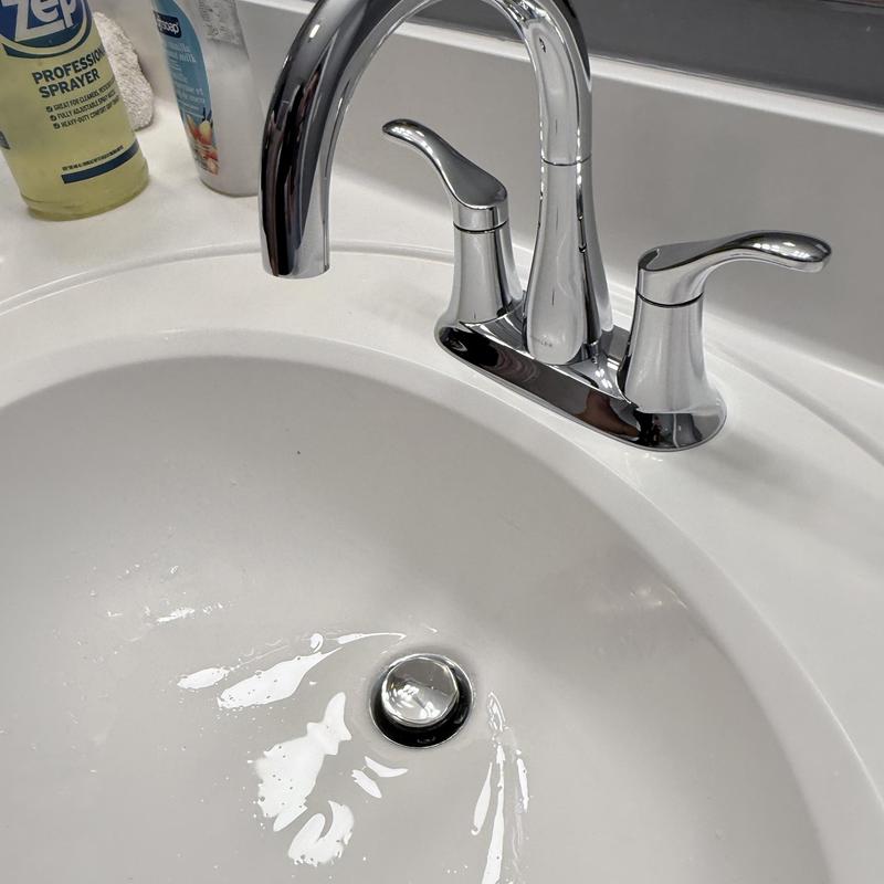 Double vanity faucet with chrome finish on white sink Double vanity faucet with chrome finish on white sink