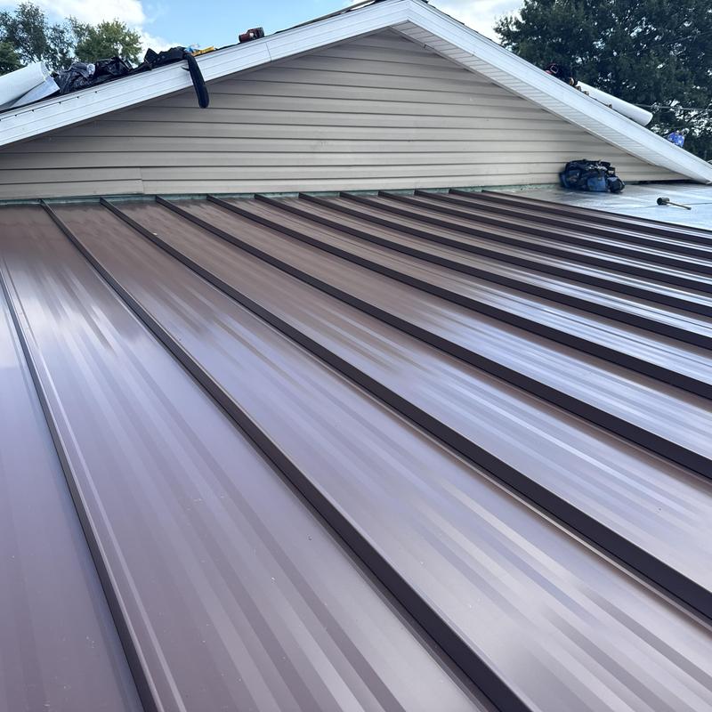 Standing seam aluminum roof panels installed on house Standing seam aluminum roof panels installed on house
