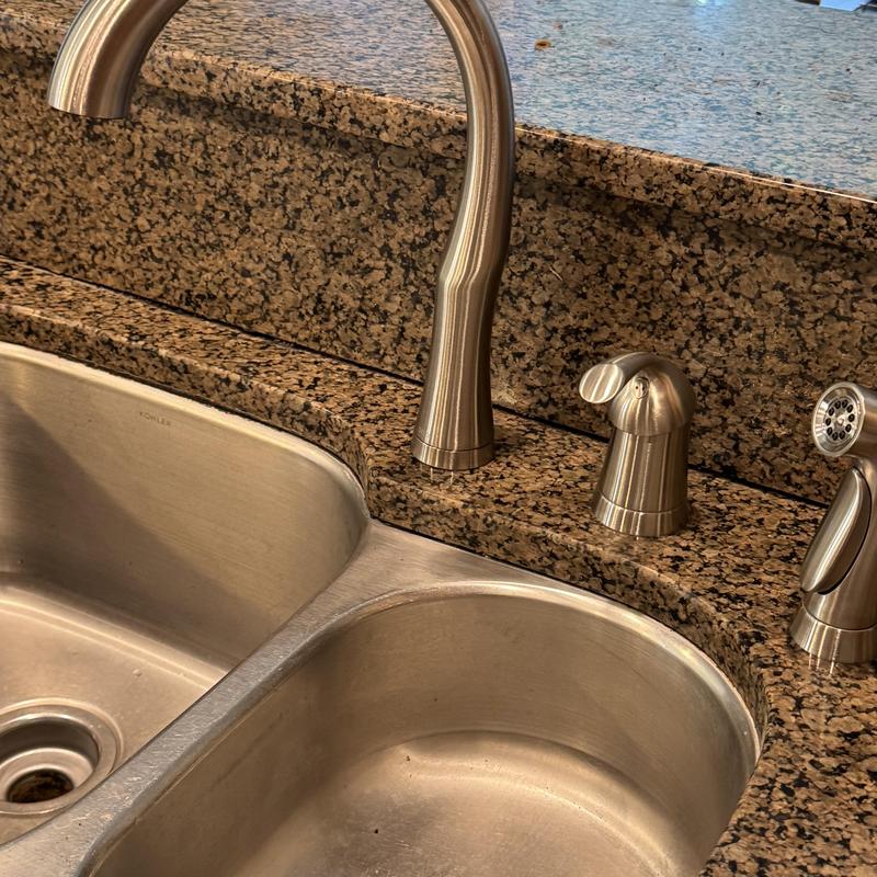 Kitchen sink faucet installation on granite countertop
