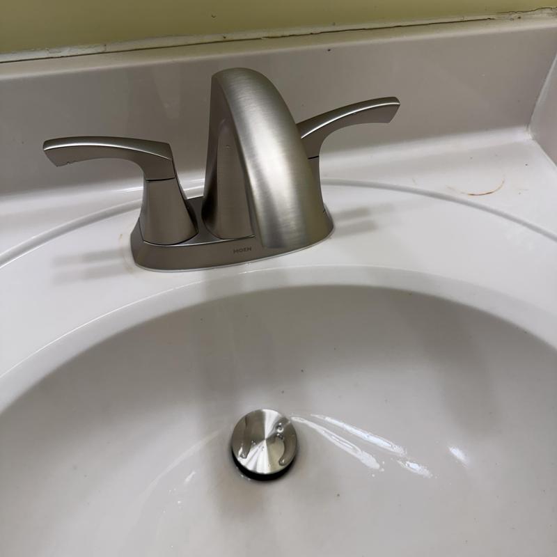 Lavatory faucet and sink with metal drain stopper