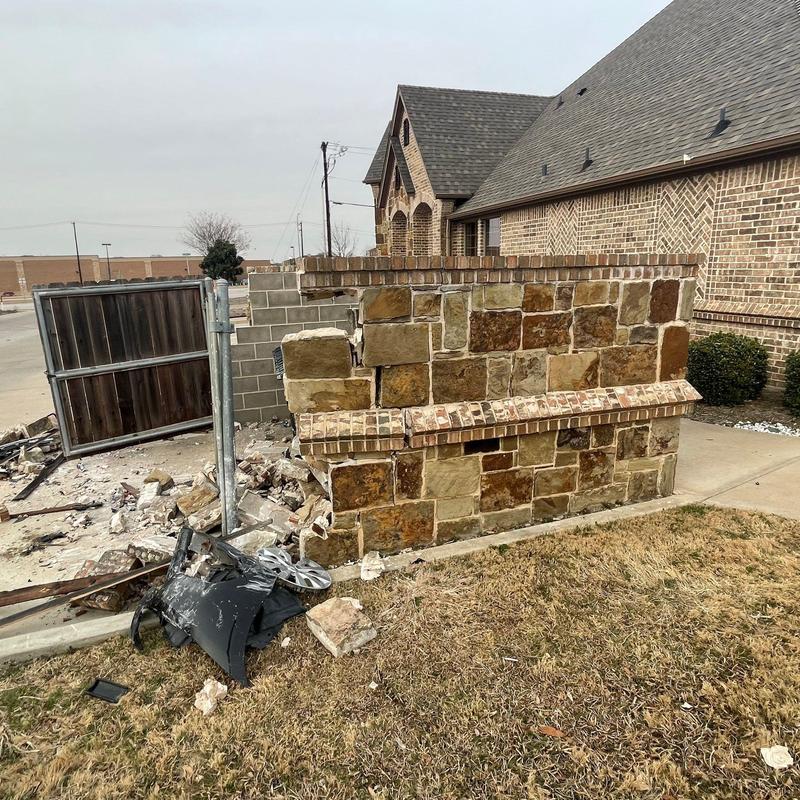 Stone wall and brick pillar with vehicle damage in Fort Worth