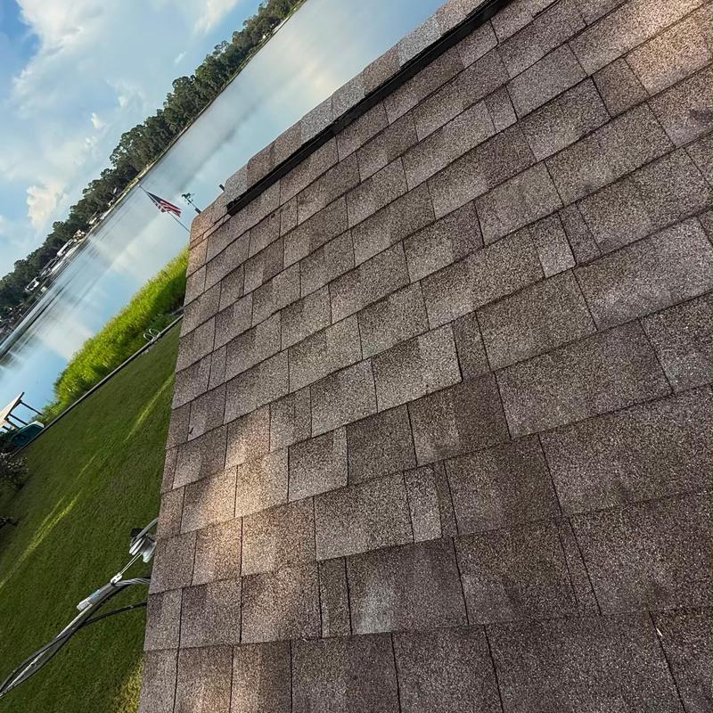 Asphalt shingles roof with repairs near lake view Asphalt shingles roof with repairs near lake view