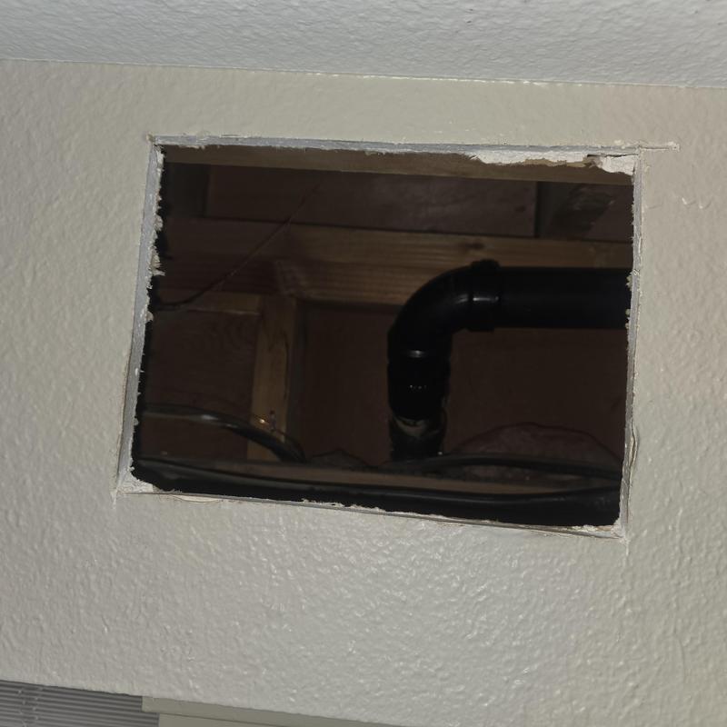 ABS drain line behind kitchen wall cutout