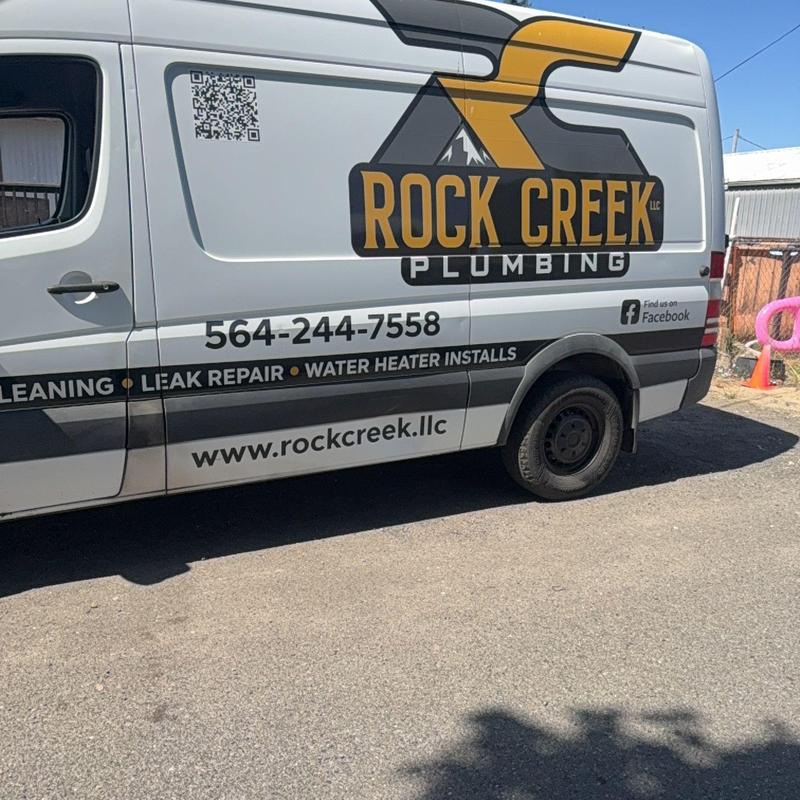 Drain snaking service van with Rock Creek Plumbing logo