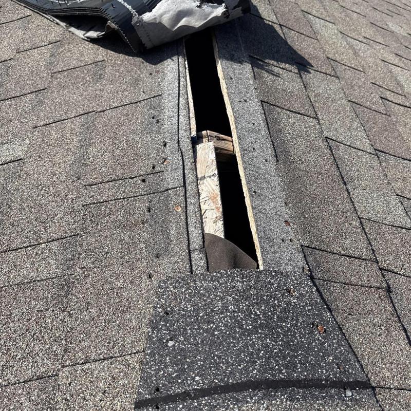 Asphalt shingle roof with storm damage and missing shingles Asphalt shingle roof with storm damage and missing shingles