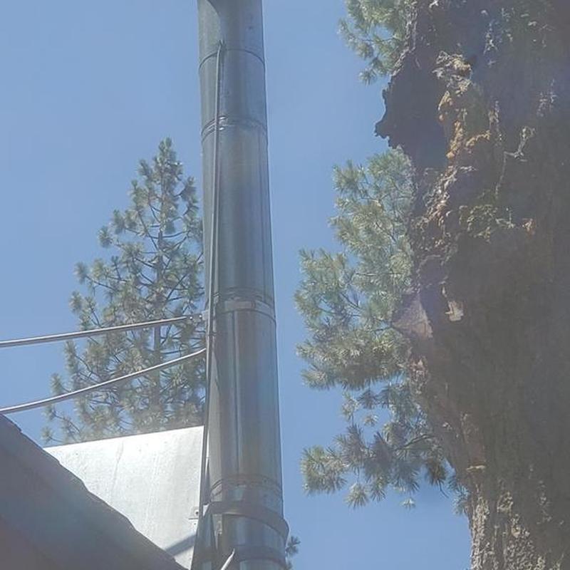 Chimney brace and snow splitter on roof
