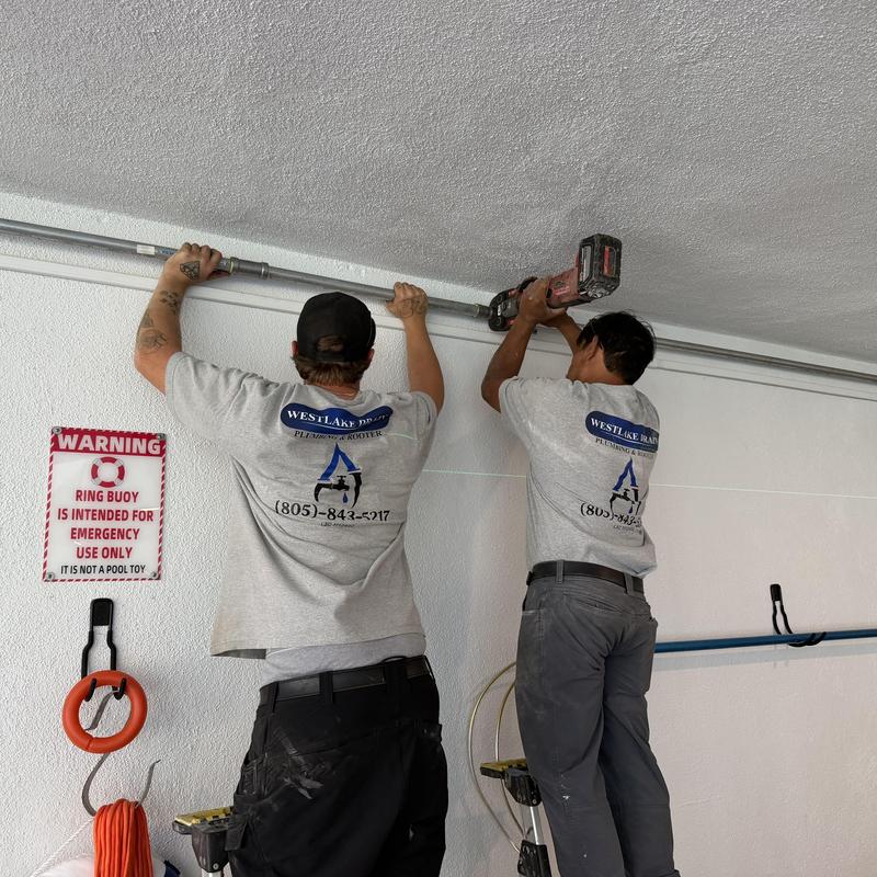 Galvanized gas piping installation on indoor pool wall
