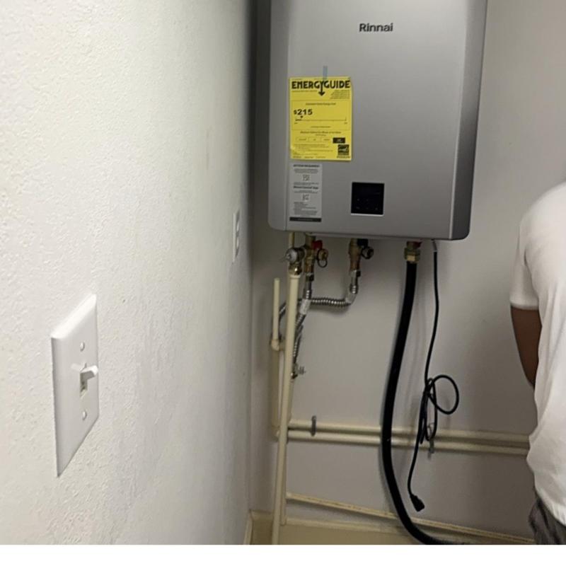 Tankless Rinnai water heater installation in utility room