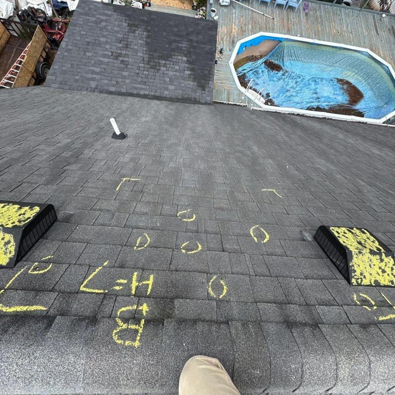 Asphalt shingle roof with hail damage markings