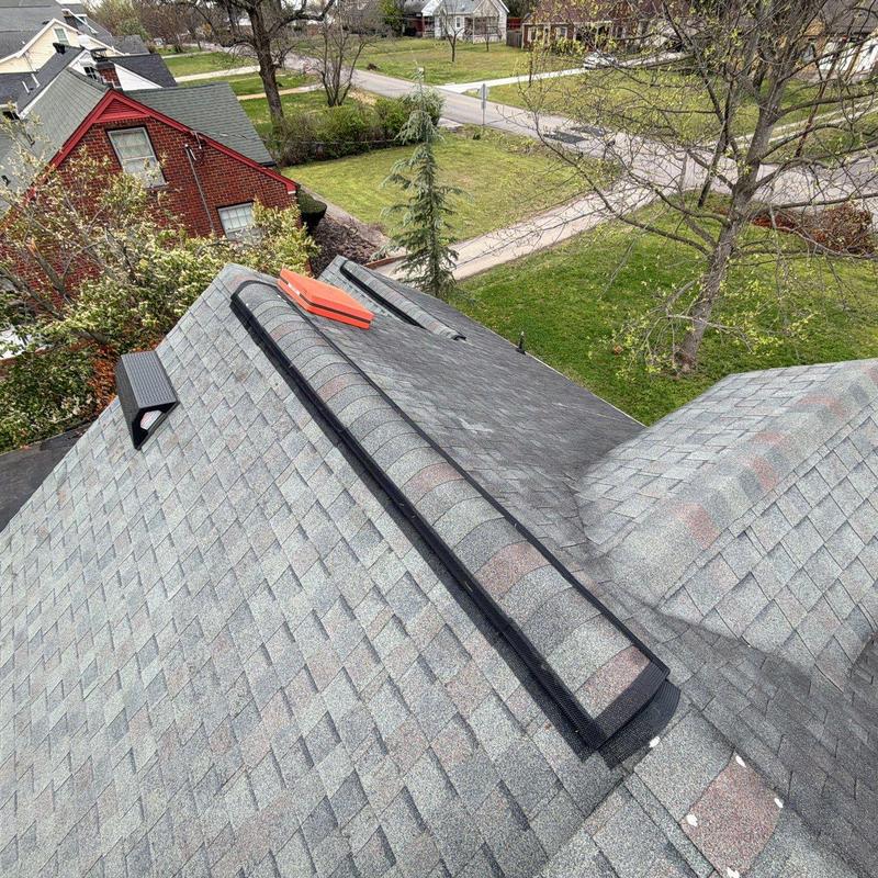 Roof ridge vent with hail damage and wear signs