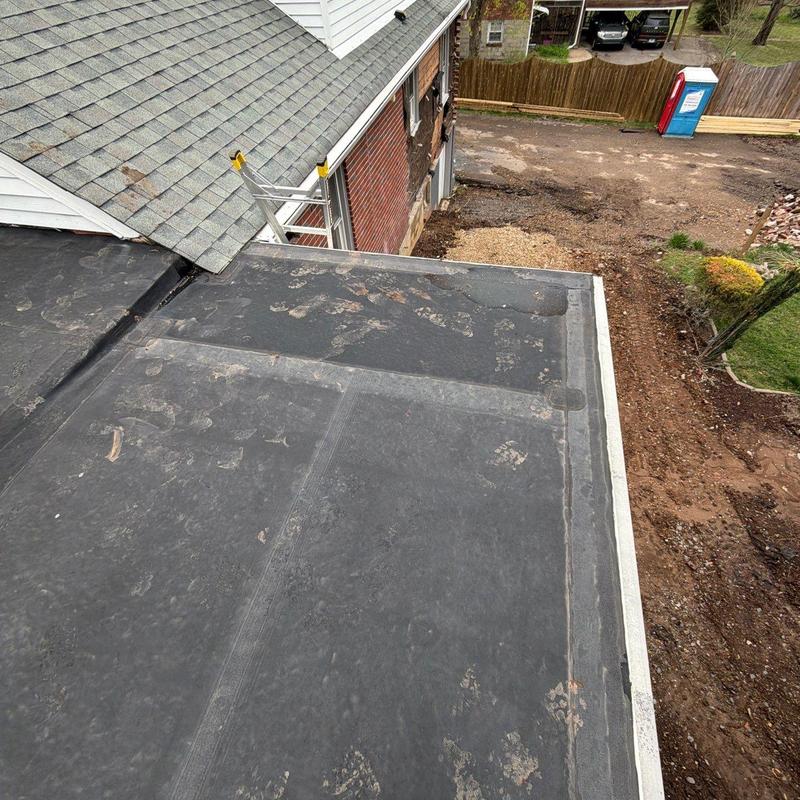 Flat roof surface with hail damage and wear marks