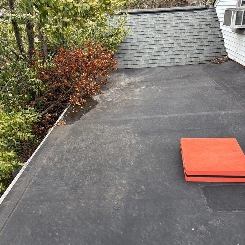 Flat roof membrane surface with ponding and debris