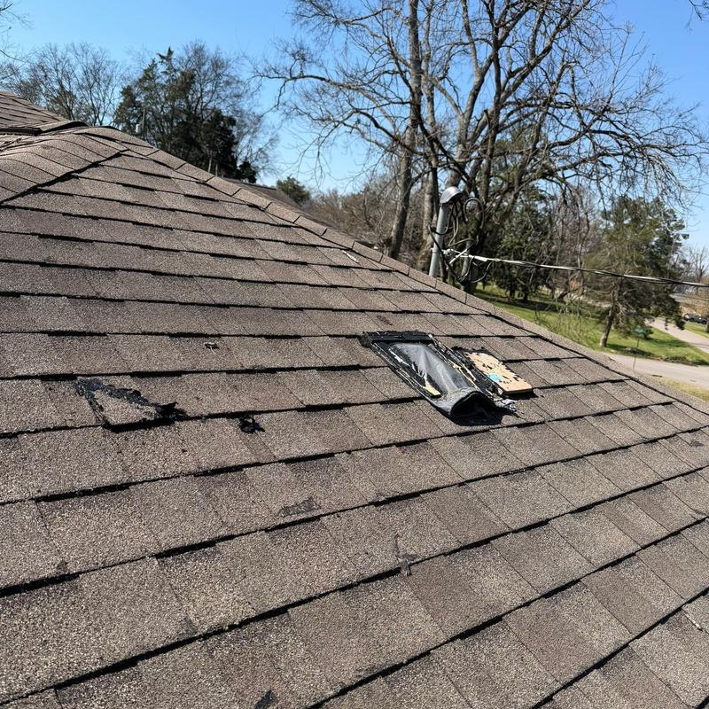 Asphalt roof shingles with hail damage and patch repairs