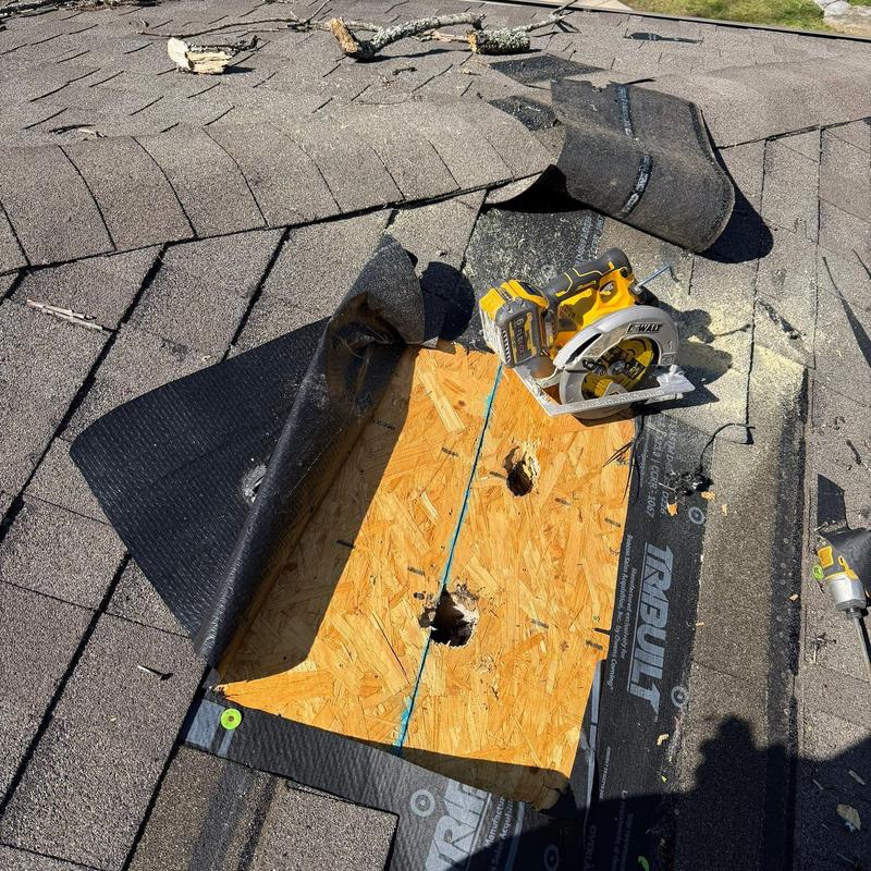 Roof decking with drill holes and circular saw on shingles