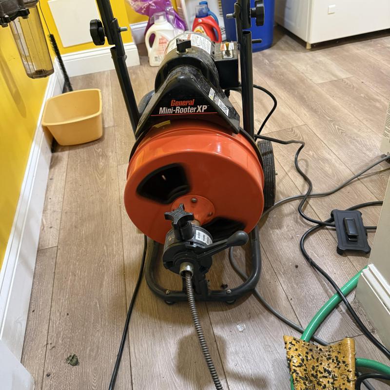 Main sewer pipe drain cleaning machine in use