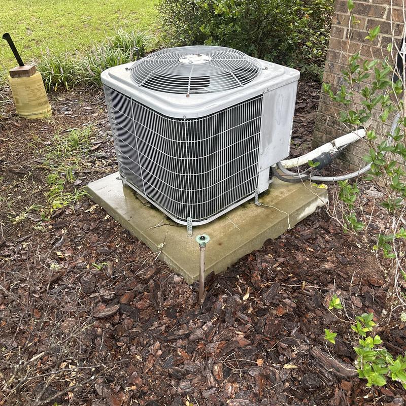 Air conditioner outdoor unit on cracked concrete pad Air conditioner outdoor unit on cracked concrete pad