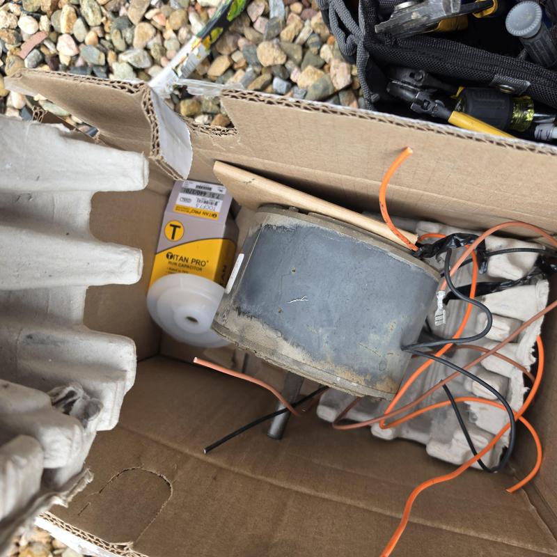 Condenser fan motor and capacitor in cardboard box Condenser fan motor and capacitor in cardboard box