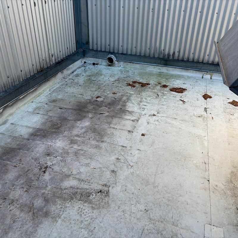 Metal roof surface with dirt and rust spots