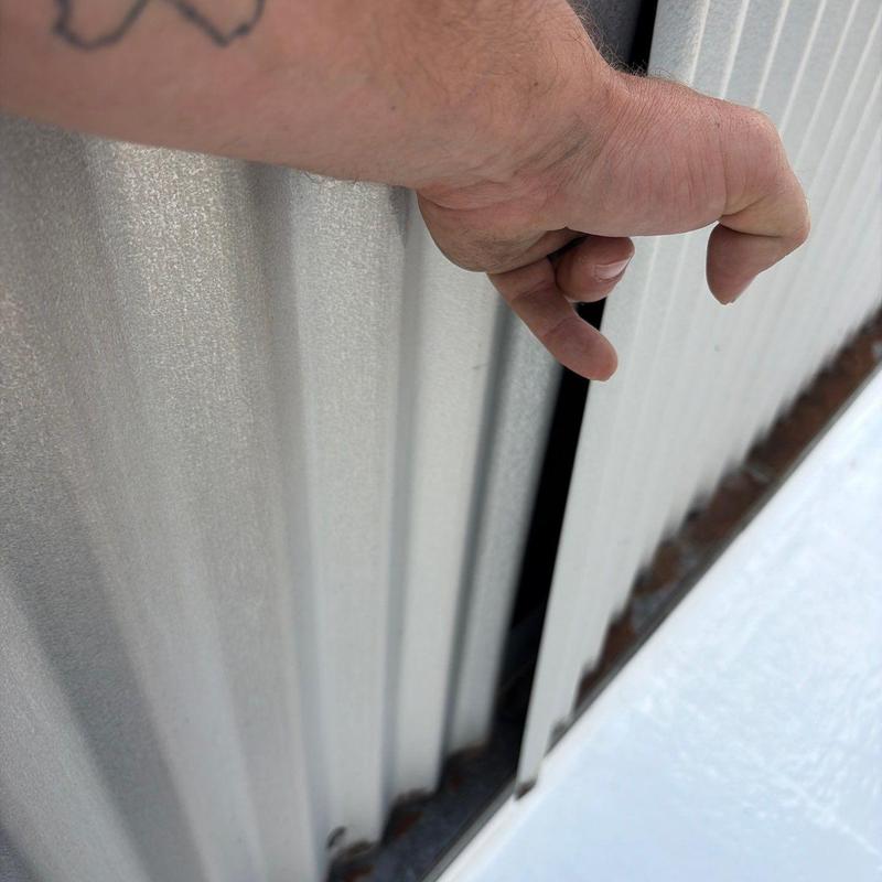 Corrugated metal wall panel gap inspection with hand