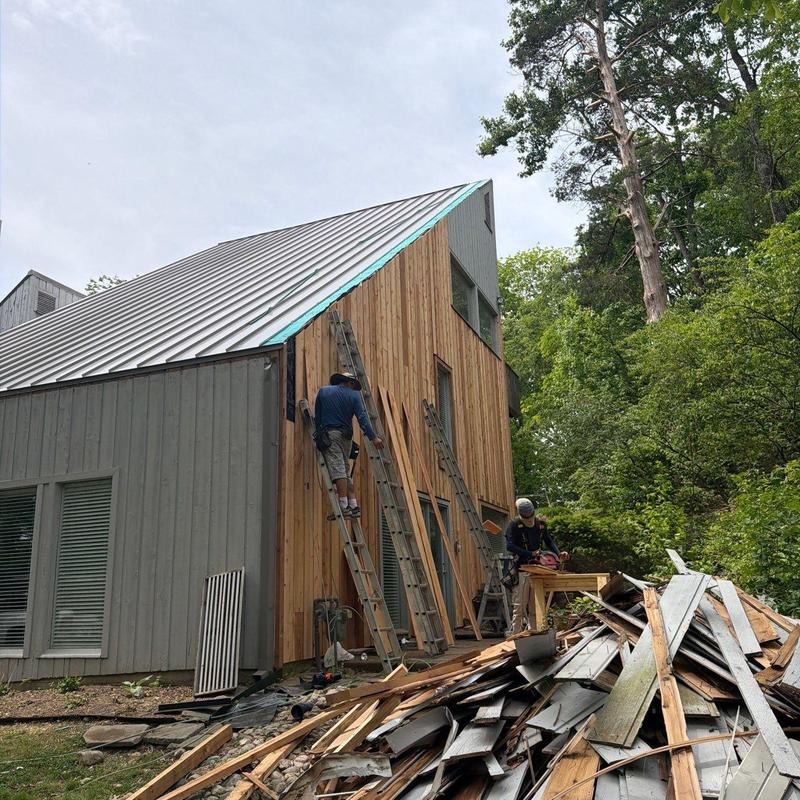 Wood siding installation with debris removal outdoors