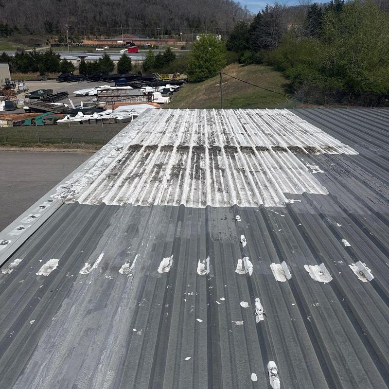 Metal roofing panels with patch repairs