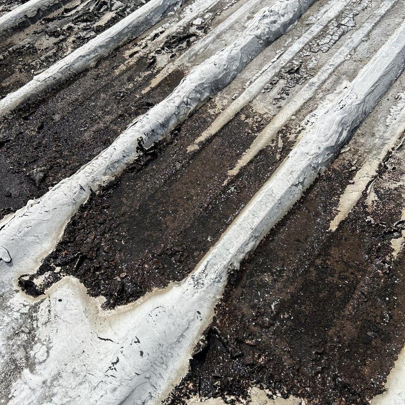 Metal roof panel rust and seam corrosion damage close-up