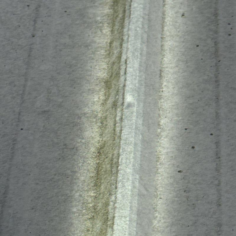 Metal roof panel with hail impact damage close-up