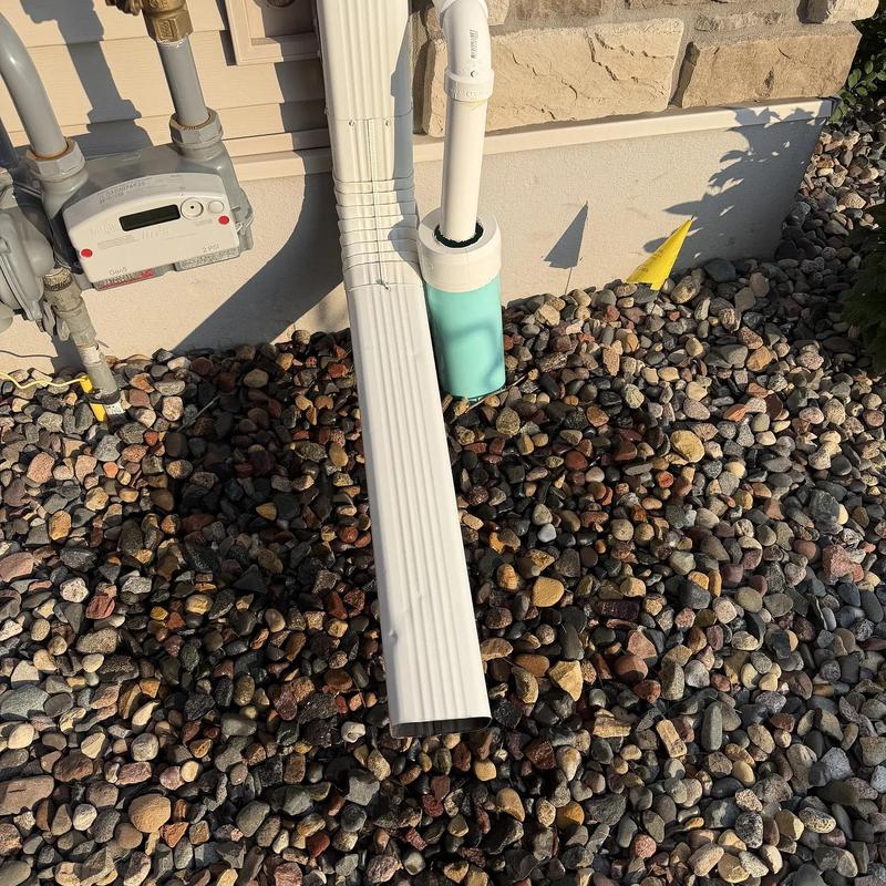 Sump pump discharge pipe with gravel backfill