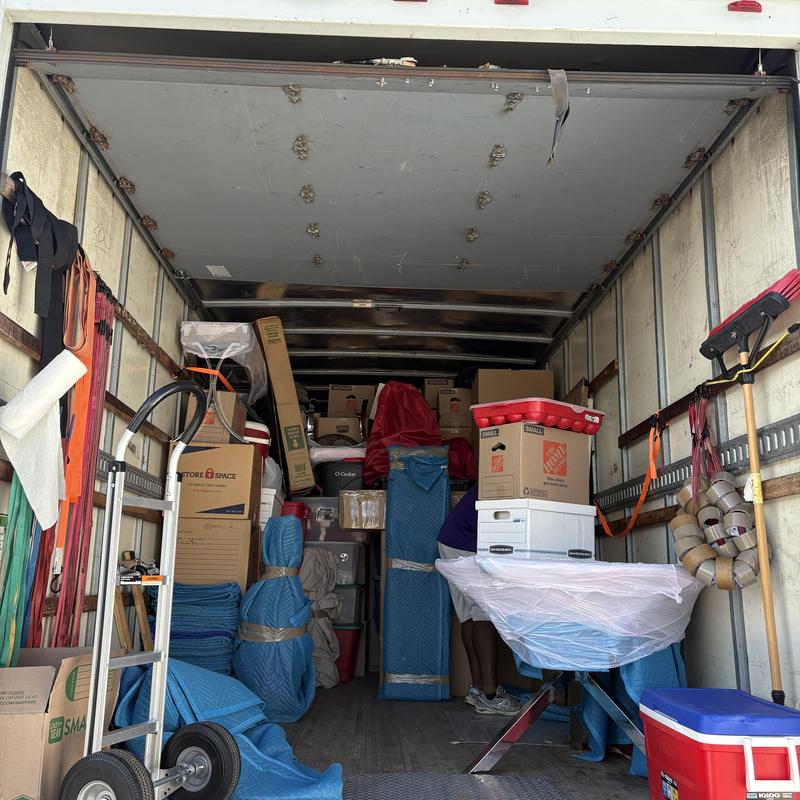Storage unit items wrapped and loaded in moving truck