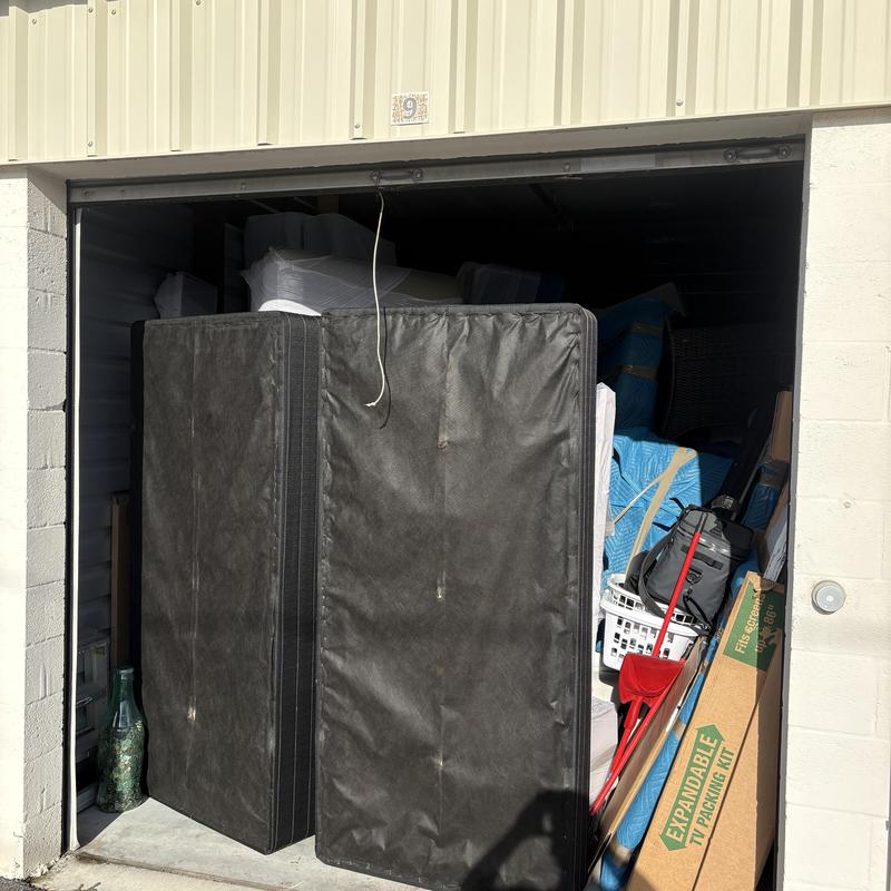 Storage unit with wrapped furniture and moving supplies