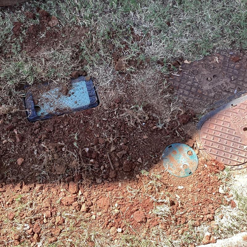 Pressure reducing valve and pipe installation with soil backfill