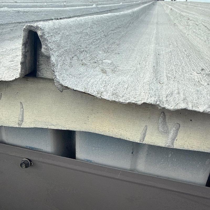 Metal roof panels with hail damage close-up