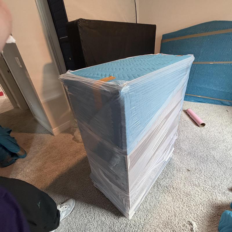 Mattress wrapped in protective plastic for moving