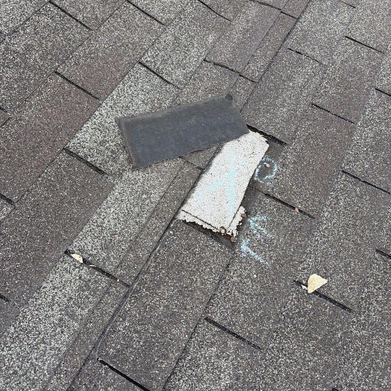 Asphalt shingles with hail damage and missing granules
