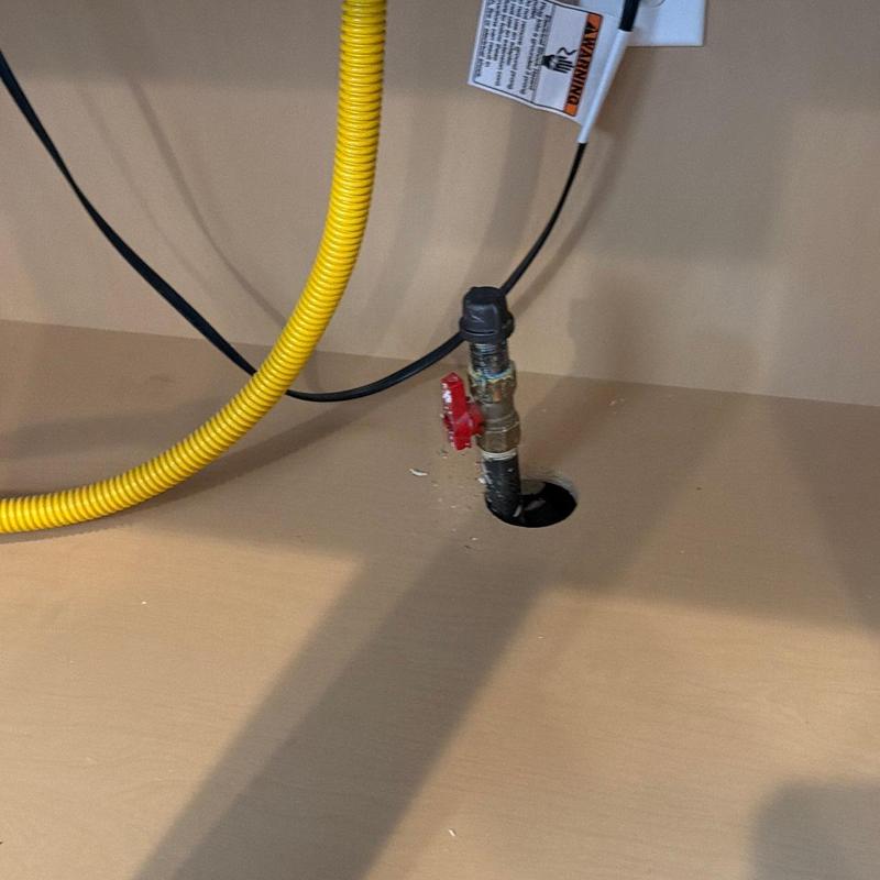 Gas line shutoff valve with cap and yellow corrugated tubing Gas line shutoff valve with cap and yellow corrugated tubing