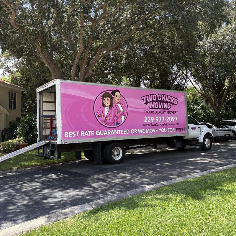 Moving truck with ramp parked on residential street