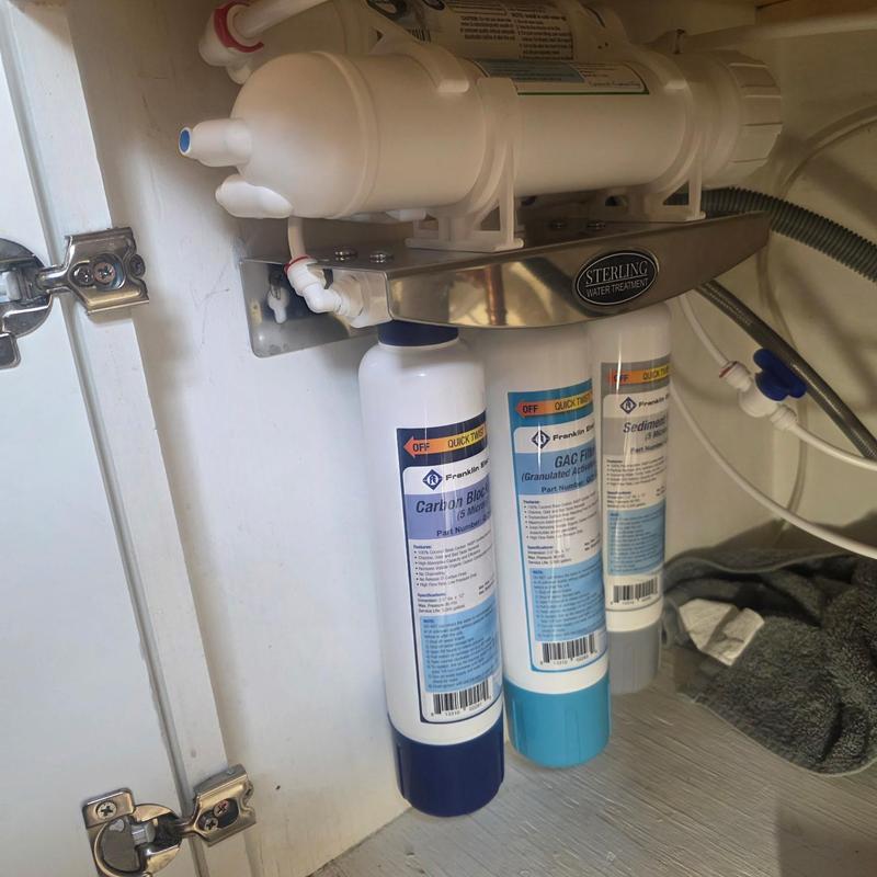 RO water filtration system with filters installed under sink