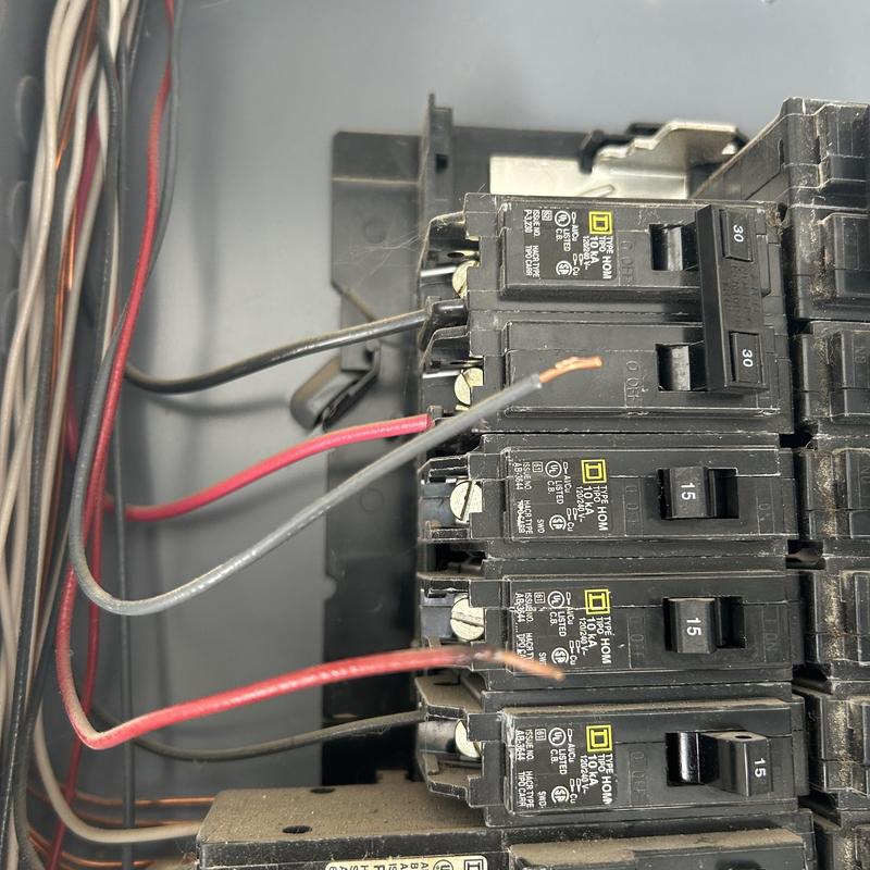 Electrical panel breakers with exposed wiring repairs Electrical panel breakers with exposed wiring repairs