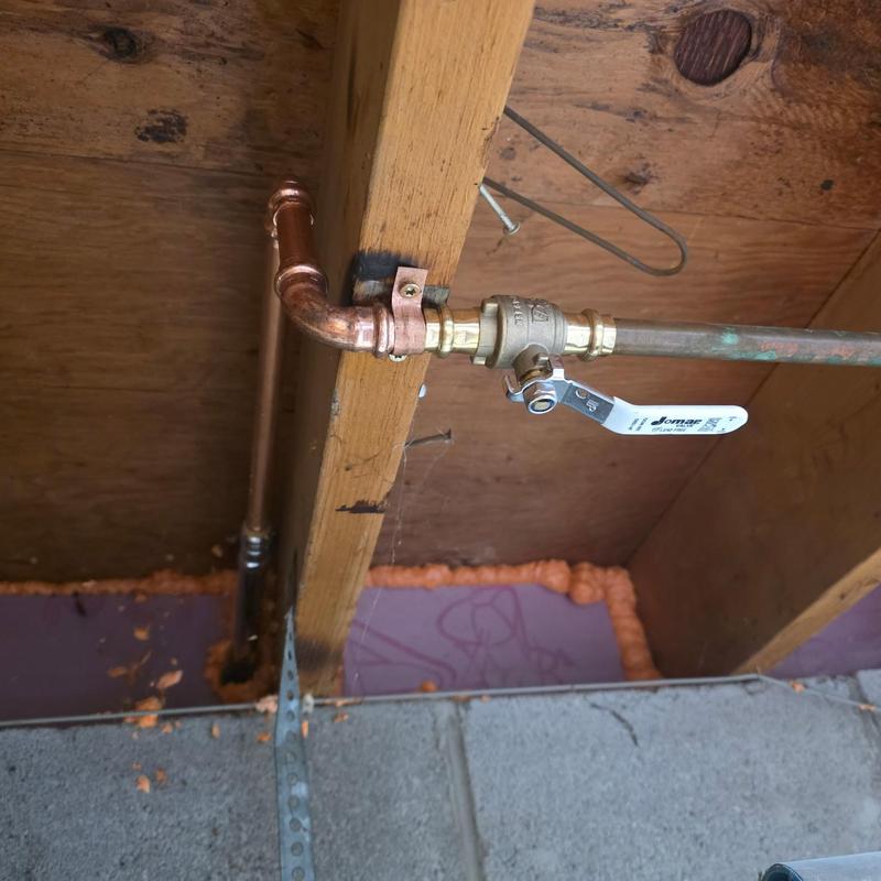Hose bib valve with copper piping in crawl space