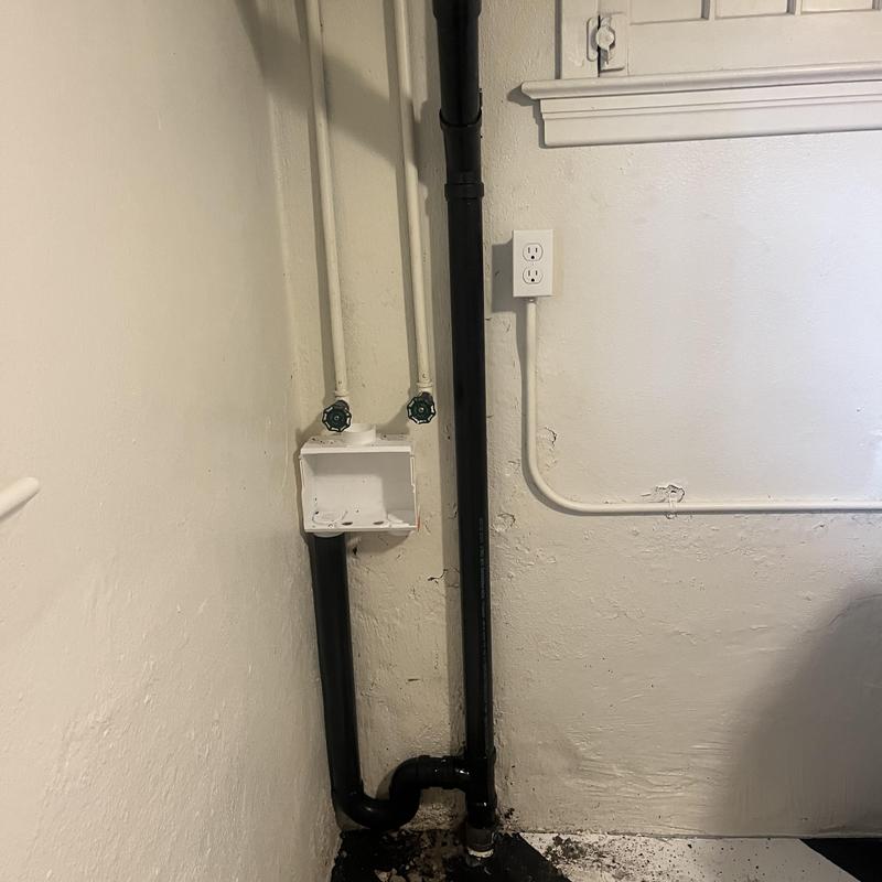 Cast iron piping with water supply valves in utility room Cast iron piping with water supply valves in utility room