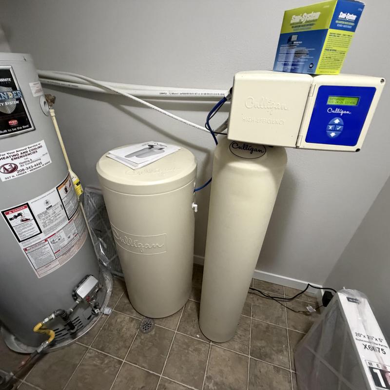 Water softener system with control unit in utility room Water softener system with control unit in utility room
