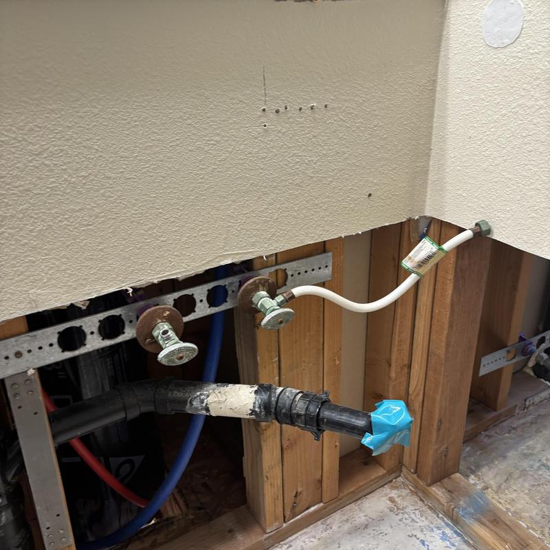 Drain pipe with temporary tape seal in wall cavity Drain pipe with temporary tape seal in wall cavity