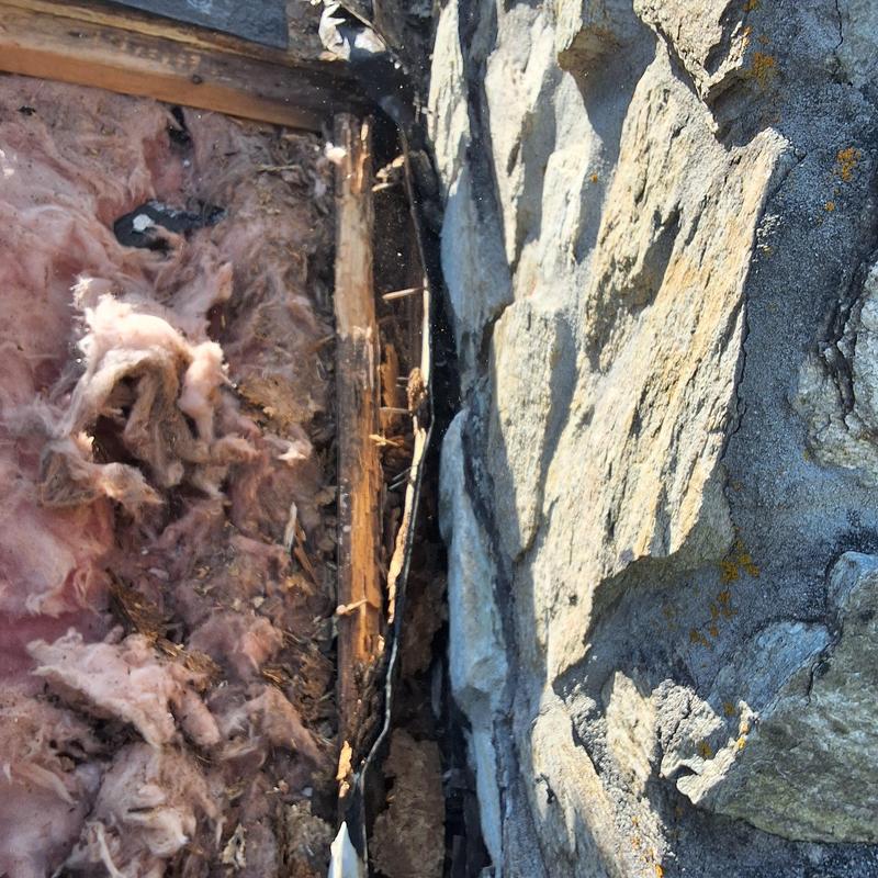 Stone chimney substructure with water damage and insulation Stone chimney substructure with water damage and insulation