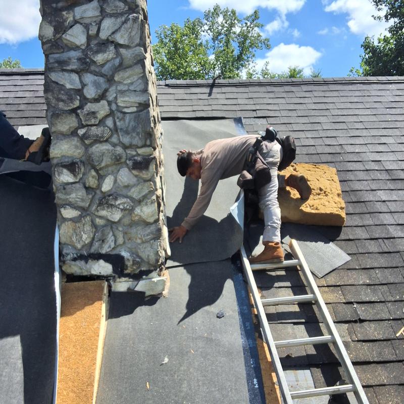 Stone chimney flashing installation on roof Stone chimney flashing installation on roof