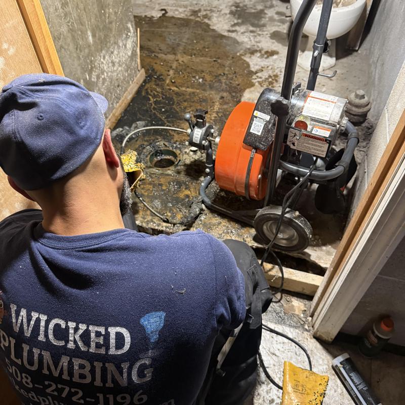Main sewer pipe cleaning with drain machine in basement Main sewer pipe cleaning with drain machine in basement