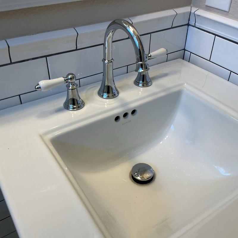 Widespread lavatory faucet and pop-up drain assembly