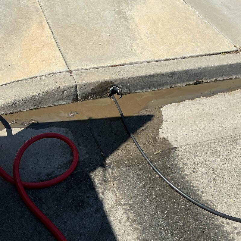 Area drain line with hydro jet cleaning hose
