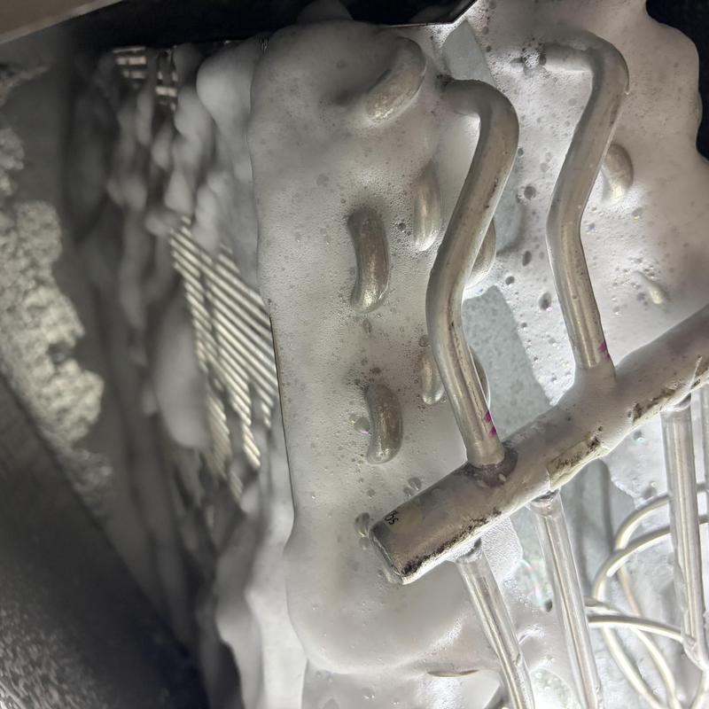 Evaporator coil covered in cleaning foam during service Evaporator coil covered in cleaning foam during service